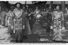 Eunuchs of Qing dynasty before 1908.  The caption reads: "In solemn majesty, the empress dowager Cixi of China is borne through courtyard of her Summer Palace by royal eunuchs"